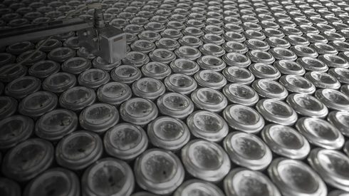 Rows of aluminium cans being sorted at factory
