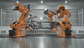 Industrial robotic arms welding a car body on an automated automotive manufacturing production line