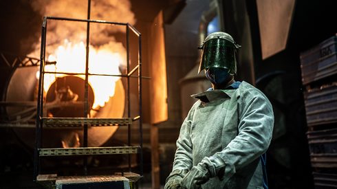 A furnace operator responsible for managing, monitoring, and controlling furnaces in manufacturing, smelting, and refining processes.