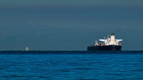 A shipping tanker sailing through the Straight of Hormuz on a sunny day