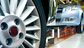 close up of car wheel in automobile manufacturing factory assembly line, USA