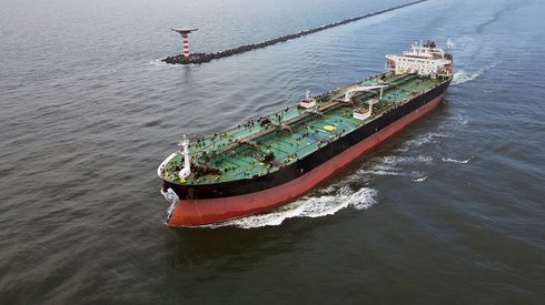 Aerial view of a large and empty oil tanker leaving the port of Rotterdam, The Netherlands.