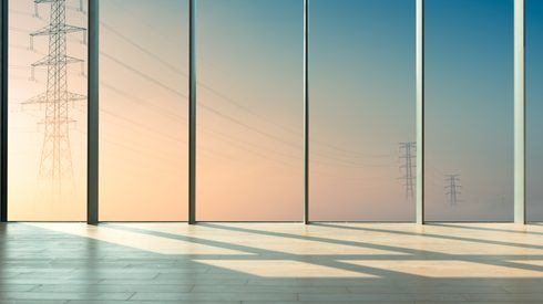 High-voltage electrical towers peeking out from the fog