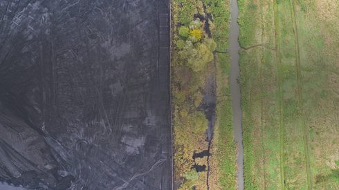 Coal field next to field of grass