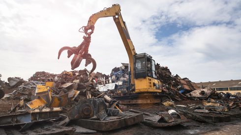 steel scrap prices - Crane loading steel scrap at steel scrap yard