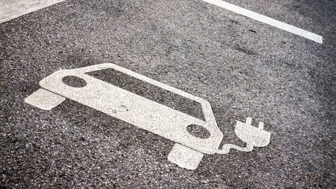 painted symbol on road of electric vehicle and charger